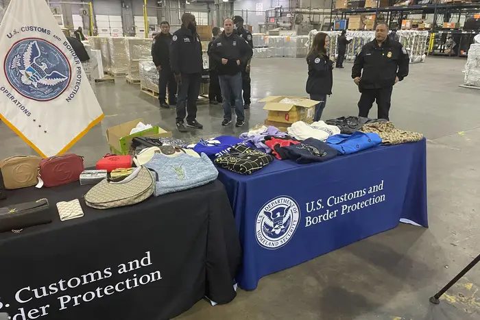 Officials display counterfeit goods at a press conference Thursday